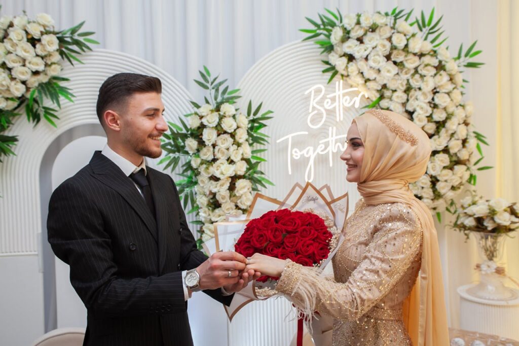 Smiling Newlyweds Putting Rings on Hands