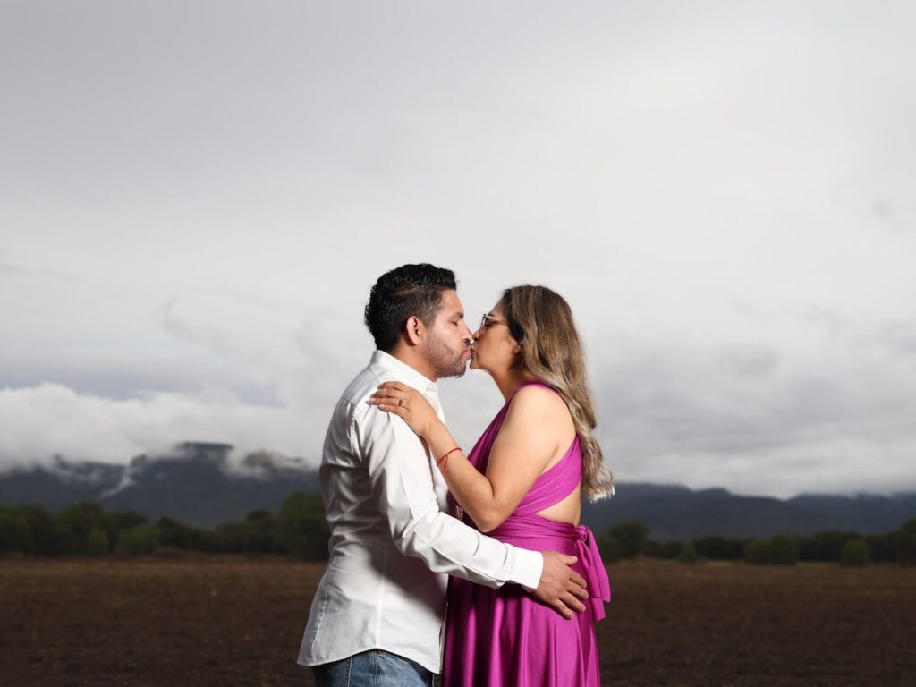 Couple Kissing on a Field