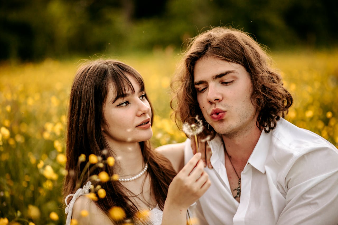 Woman Hugging Man Blowing Dandelion