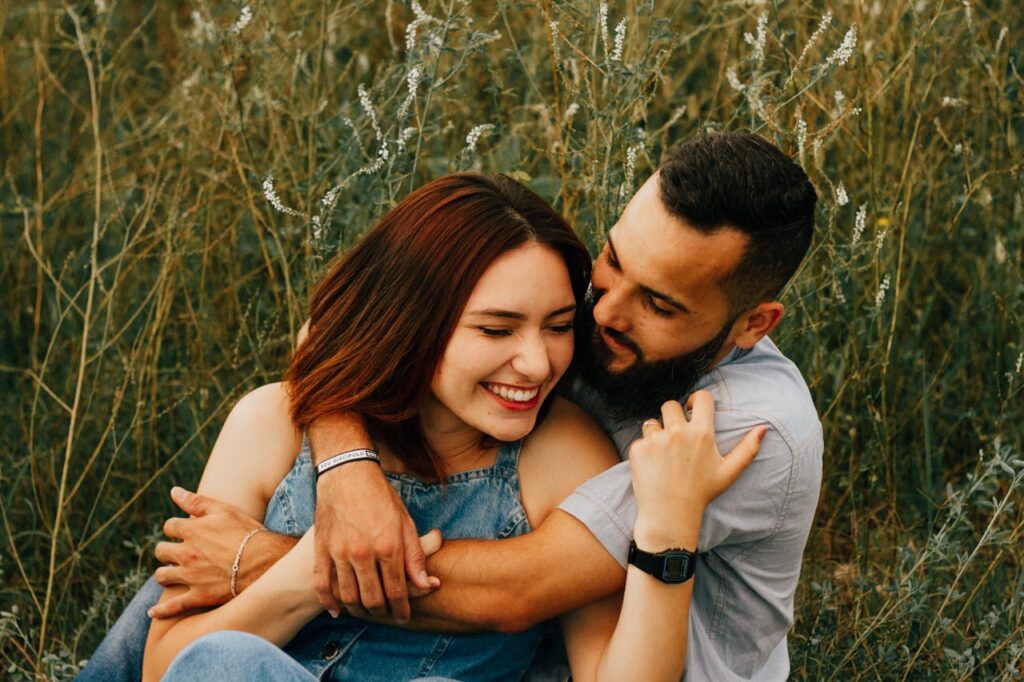 Smiling Woman and Man Sitting Together and Hugging