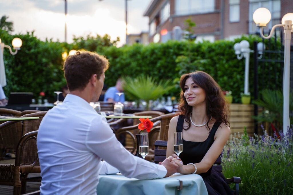 Couple Sitting by Table on Restaurant Terrace